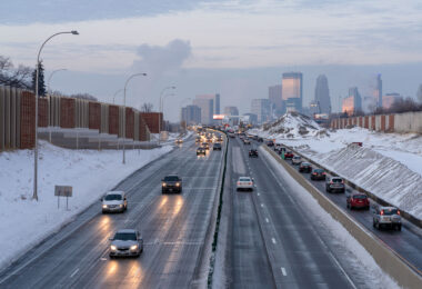 Road construction on interstate 35W in South Minneapolis with the city skyline in the background.