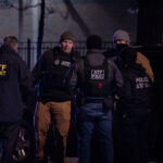 The ATF and DEA gather outside the Holiday Gas station where Dolal Idd was shot and killed by Minneapolis Police on December 31, 2020.