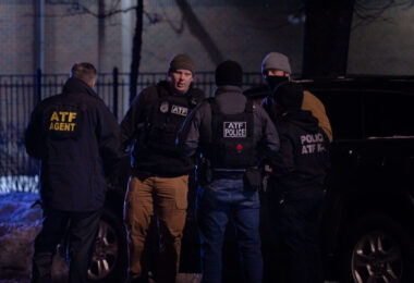 The ATF and DEA gather outside the Holiday Gas station where Dolal Idd was shot and killed by Minneapolis Police on December 31, 2020.