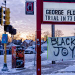 The sun sets to the west of George Floyd Square on the first day of Kwanzaa. Day 1 represents Umoja (Unity). The countdown to the Derek Chauvin trial was recently added to what was a Speedway sign. The area has been a protest zone since the May 25th, 2020 death of George Floyd.