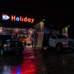 Workers board up windows at Holiday Gas on Cedar Ave in South Minneapolis in preparation for any possible unrest following the Minneapolis Police shooting of Dolal Idd. Earlier in the year George Floyd was killed by Minneapolis police a mile away.