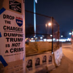 Flyers taped to a pole outside of the Minneapolis Third Precinct police station, which burned after the murder of George Floyd in May 2020. Drop the charges refers to the 646 that were criminally charged during the largest mass arrest in Minnesota history. Protesters were arrested after marching onto I-94 in a post election march.