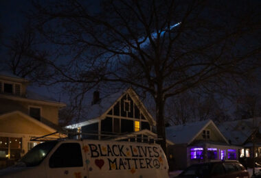 A helicopter shines it's light down towards protesters outside the gas station where Dolal Idd was killed by Minneapolis Police. Protesters had begun gathering.