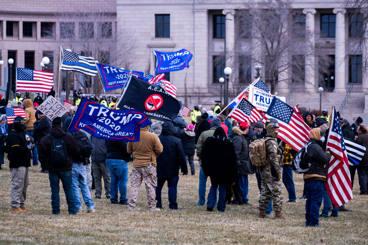 Protesters wave “Trump 2020” flags at a Stop The Steal rally at the Minnesota State Capitol on December 12, 2020.