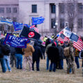 Protesters wave “Trump 2020” flags at a Stop The Steal rally at the Minnesota State Capitol on December 12, 2020.