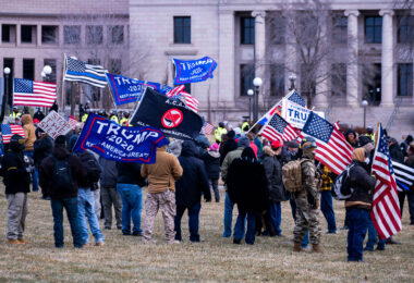Protesters wave “Trump 2020” flags at a Stop The Steal rally at the Minnesota State Capitol on December 12, 2020.