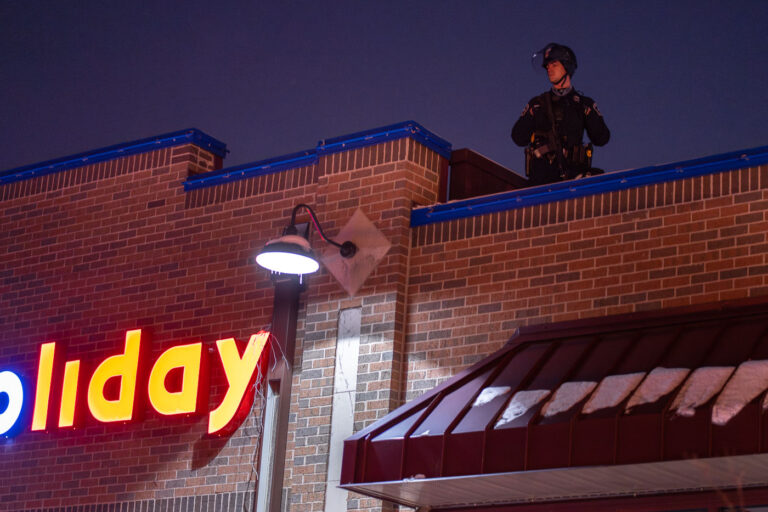 Minneapolis police on roof of Holiday Gas 3 Minneapolis Police on the roof of the Holiday gas station as protesters gather outside where Minneapolis police shot and killed Dolal Idd.