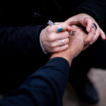 Jail support number written on a protester 2 A Stop The Steal counter protester gets the National Lawyer's Guild Number written on their hand in the event of arrest.