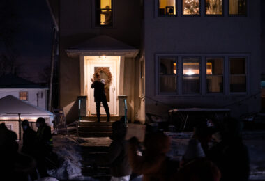 A neighbor comes out to show his support as protesters march down 17th Ave the night after Dolal Idd was killed by Minneapolis Police.