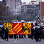 Protesters march against fascism in downtown St. Paul. The protesters marched through downtown with large banners.