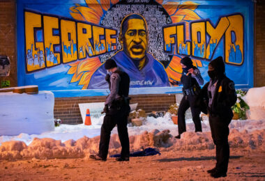 Officers look for evidence inside George Floyd Square after responding to a shooting on December 27, 2020.