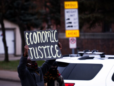Minneapolis Protester with "Economic Justice" Sign
