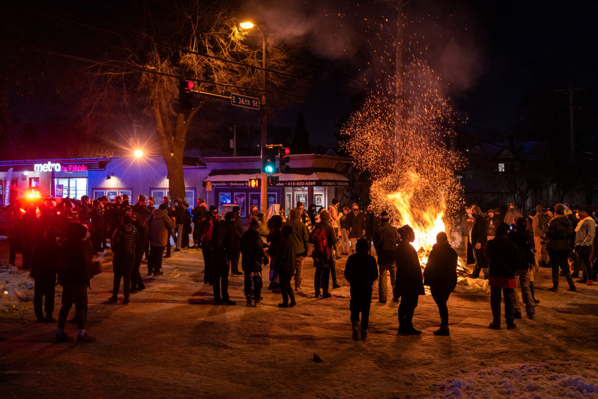 Protesters gather in the street outside the gas station where Minneapolis police killed Dolal Idd. Earlier in the year George Floyd was killed a mile away.