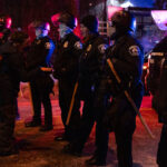 Minneapolis Police at Dolal Idd protest 2 Protesters and police outside the gas station that Dolal Idd was killed earlier in the day.