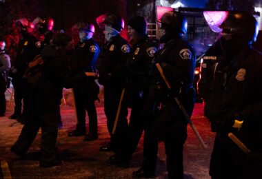 Protesters and police outside the gas station that Dolal Idd was killed earlier in the day.