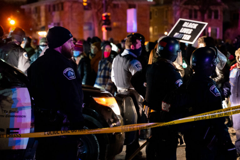Minneapolis Police and protesters after Dolal Idd was killed 4 Minneapolis police surround the Holiday Gas station where Dolal Idd was shot and killed as protesters gather.