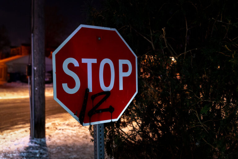 STOP 12 sign 4 “Stop 12" graffiti at Holiday Gas on Cedar Ave. The Minneapolis Police shot and killed Dolal Idd the night before on December 30th, 2020. This is one mile from where George Floyd was murdered. Minneapolis Police released video they say showed Dolal Idd shooting first through the window of his car during a firearm sting.