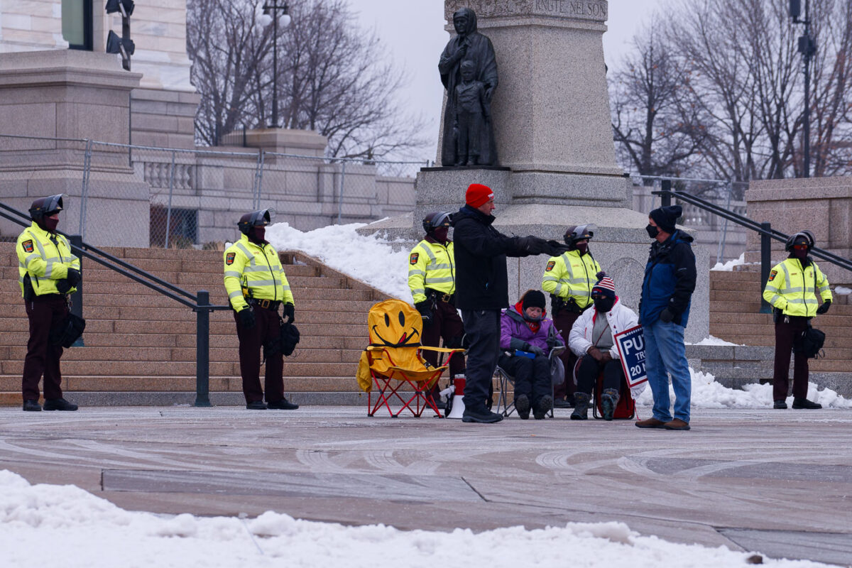 Minnesota State Patrol guards the State Capitol on reports of possible protests following a January 6th, 2021 insurrection at the United States Capitol. 3 Trump supporters at a rally.