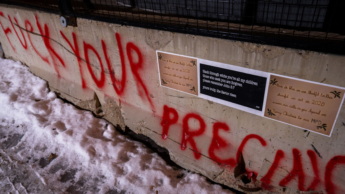 A "Merry Christmas" message to the Minneapolis Police pasted to the side of concrete barricades surrounding the former third precinct.