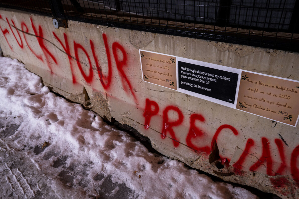 A "Merry Christmas" message to the Minneapolis Police pasted to the side of concrete barricades surrounding the former third precinct.