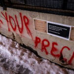 A "Merry Christmas" message to the Minneapolis Police pasted to the side of concrete barricades surrounding the former third precinct.