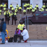 Minnesota State Patrol guards the State Capitol on reports of possible protests following a January 6th, 2021 insurrection at the United States Capitol. 3 Trump supporters at a rally.
