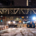 Public Works vehicles work through the night to put jersey barriers in place around government buildings across from the Hennepin County Government Center where Derek Chauvin trial begins in 19 days.