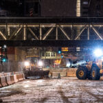 Public Works vehicles work through the night to put jersey barriers in place around government buildings across from the Hennepin County Government Center where Derek Chauvin trial begins in 19 days.