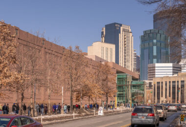 People stand in line for their turn to get the COVID-19 vaccine at the Minneapolis Convention Center.