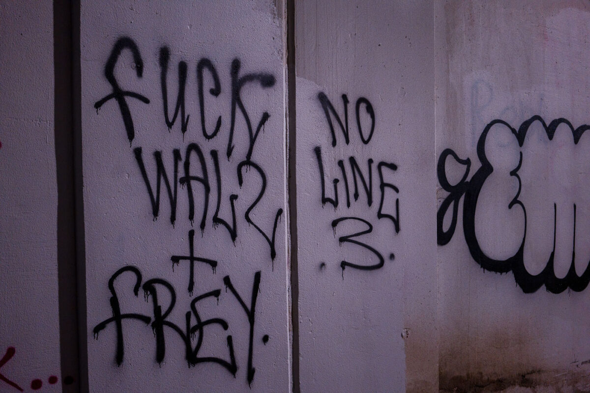 "Fuck Walz + Frey" "No Line 3" written under a bridge on the Midtown Greenway.