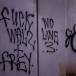 "Fuck Walz + Frey" "No Line 3" written under a bridge on the Midtown Greenway.