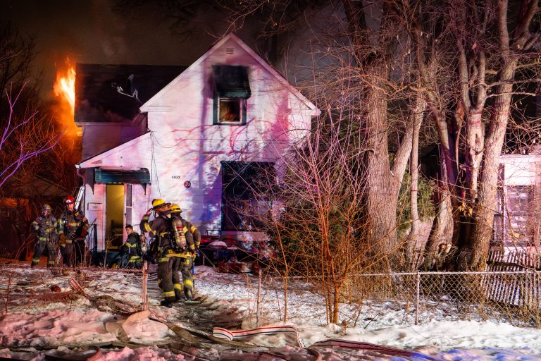 South Minneapolis House Fire Displaces Four Residents 2 Firefighters respond to a residential house fire in Minneapolis on a snowy winter night.