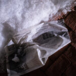 A wet newspaper lays in the snow outside the Hennepin County Government Center. Article titled “Who’s running for Mayor of Minneapolis?”