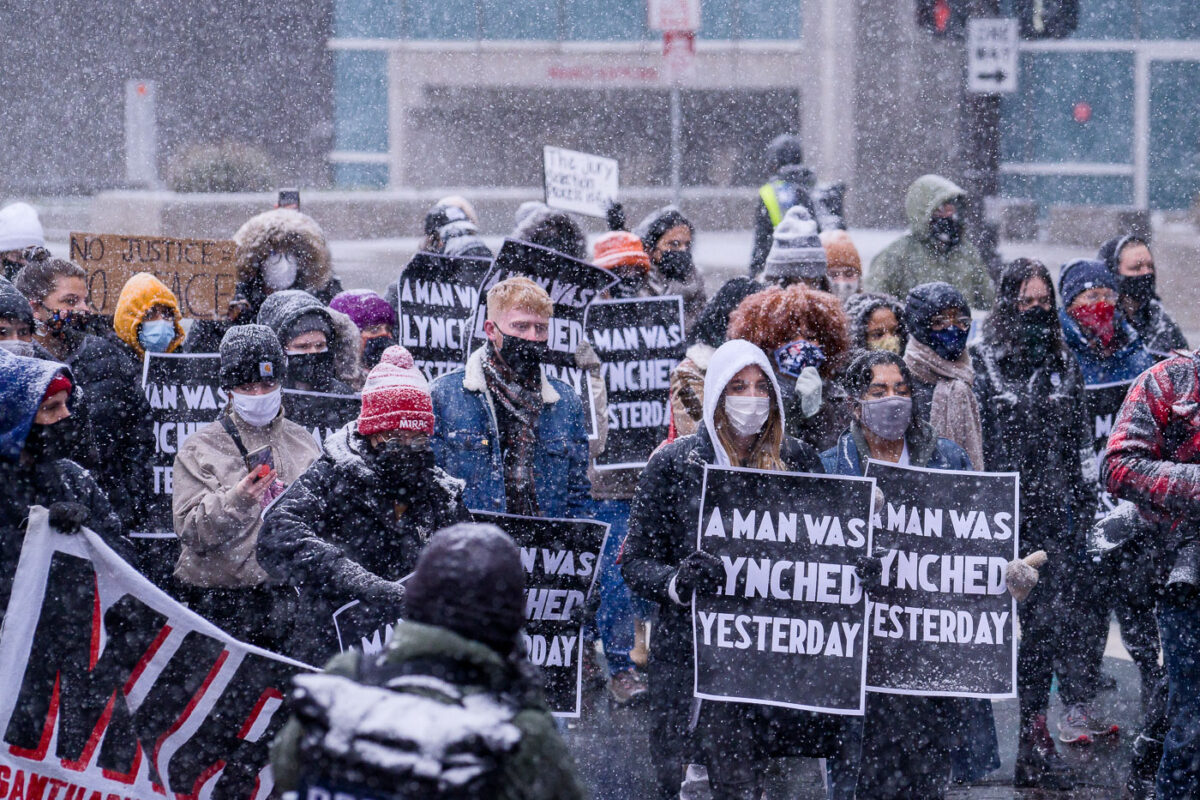 Protesters march around the Hennepin County Government Center. The courthouse is currently holding the Derek Chauvin murder trial. Chauvin is charged in the May 25th murder of George Floyd in South Minneapolis.