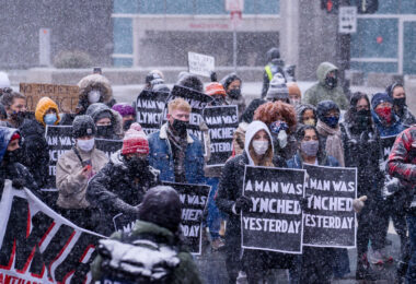 Protesters march around the Hennepin County Government Center. The courthouse is currently holding the Derek Chauvin murder trial. Chauvin is charged in the May 25th murder of George Floyd in South Minneapolis.