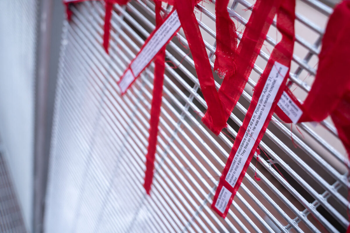 Protesters tie ribbons with stories of police brutality to the security fencing around the Hennepin County Government Center on the day opening statements began in the Derek Chauvin murder trial. Chauvin is accused of murdering George Floyd on May 25th, 2020.