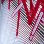 Protesters tie ribbons with stories of police brutality to the security fencing around the Hennepin County Government Center on the day opening statements began in the Derek Chauvin murder trial. Chauvin is accused of murdering George Floyd on May 25th, 2020.