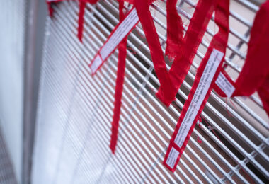 Protesters tie ribbons with stories of police brutality to the security fencing around the Hennepin County Government Center on the day opening statements began in the Derek Chauvin murder trial. Chauvin is accused of murdering George Floyd on May 25th, 2020.