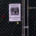 A sign hanging on a fence around the Hennepin County Government Center that reads "Bringing in the National Guard. What could possibily go wrong?".