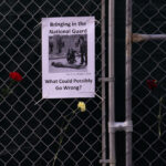 Bringing In the National Guard flyer 3 A sign hanging on a fence around the Hennepin County Government Center that reads "Bringing in the National Guard. What could possibly go wrong?".