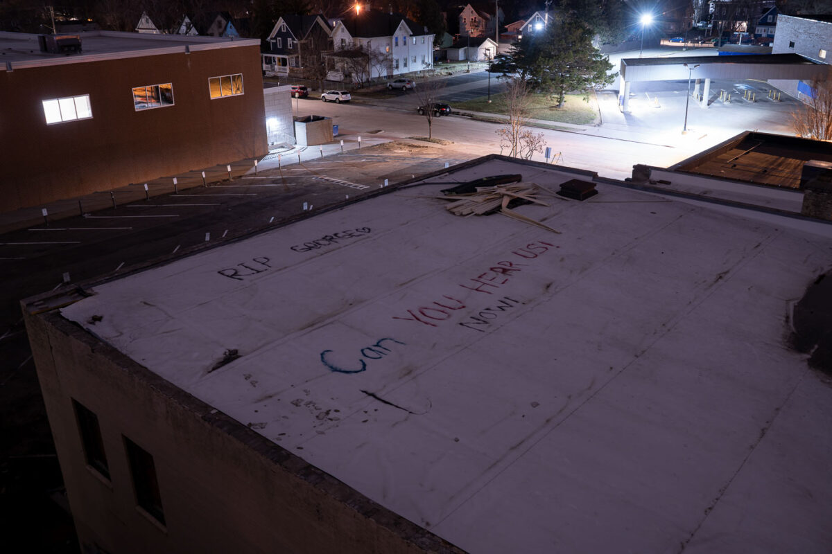 "RIP George" "Can you hear us now!" written on a rooftop of a building across from the Minneapolis Police Third Precinct. The Third Precinct was burned during unrest over the May 25th murder of George Floyd.