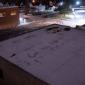 "RIP George" "Can you hear us now!" written on a rooftop of a building across from the Minneapolis Police Third Precinct. The Third Precinct was burned during unrest over the May 25th murder of George Floyd.