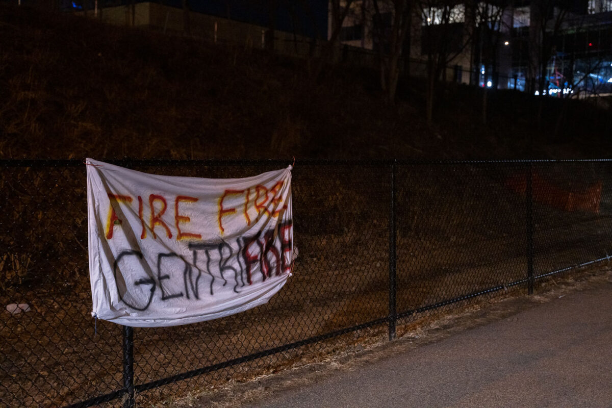 A protest sign seen on the Midtown Greenway that reads "Fire Fire Gentrifire"