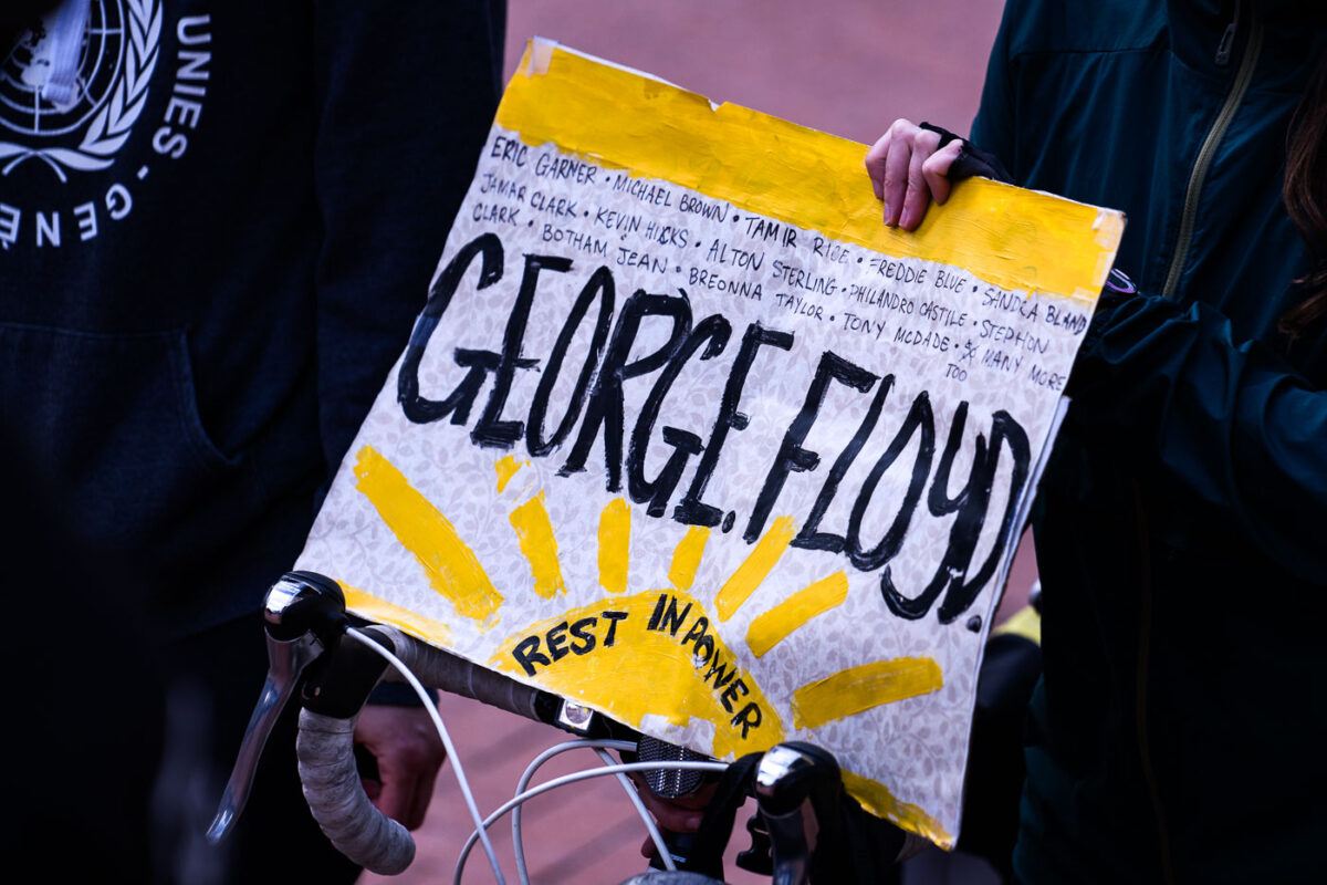 A protester holds up a George Floyd Rest In Power sign at a march during the Derek Chauvin murder trial in Minneapolis.