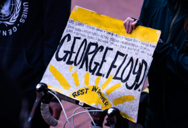 A protester holds up a George Floyd Rest In Power sign at a march during the Derek Chauvin murder trial in Minneapolis.
