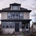 A sign reading "Justice 4 George" on a home in South Minneapolis.