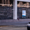 Boards on the US Bank Building with chalk writing on it.