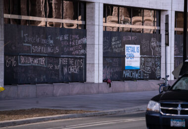 Boards on the US Bank Building with chalk writing on it.