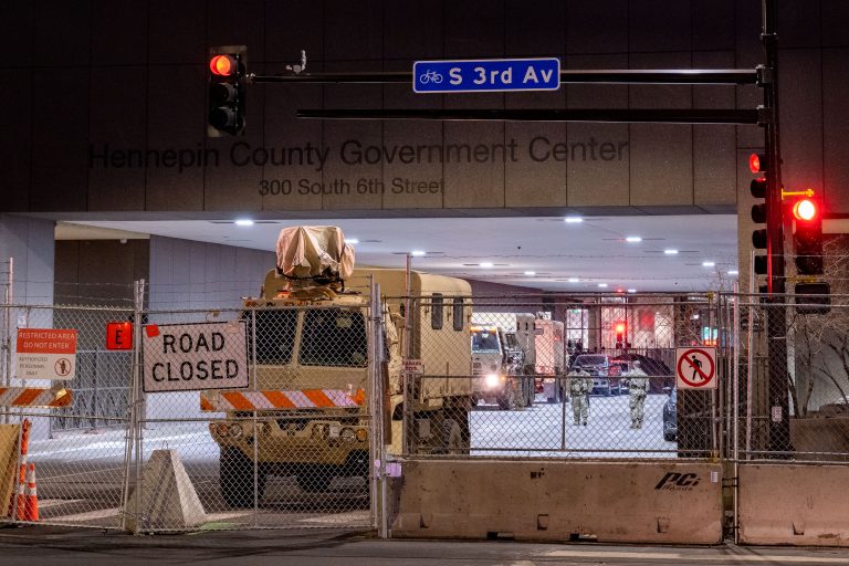 National Guard vehicles at Hennepin County Government Center 3 Military vehicles behind razor wire for Chauvin murder trial