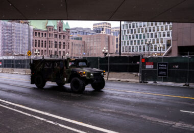 A military vehicle drives around the Hennepin County Government Center. The courthouse is currently holding the Derek Chauvin murder trial. Chauvin is charged in the May 25th murder of George Floyd in South Minneapolis.